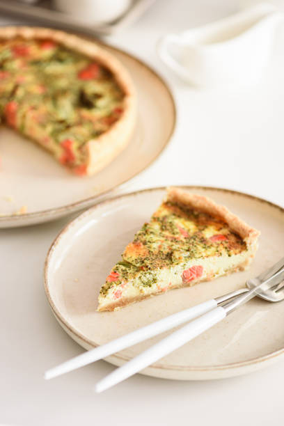 istock French quiche lauren with salmon, cheese and broccoli on white table. Soft focus 2156941033