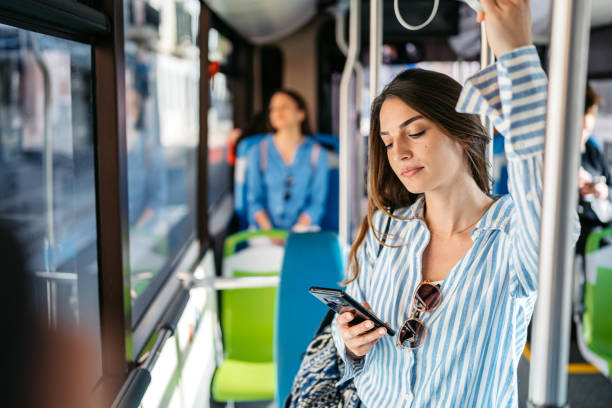 istock Young Woman Using Phone While Riding In A Bus In Palma De Mallorca In Spain 2156942177