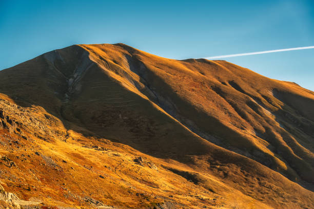 istock Rocky mountain covered in brown grass and sunlight shine in rural scene 2156943384