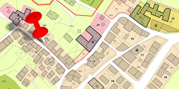 istock Real Estate and Building Activity concept with red location pin point against an imaginary General Urban Plan with zoning regulations, urban districts, urban destinations and land use 2156943718