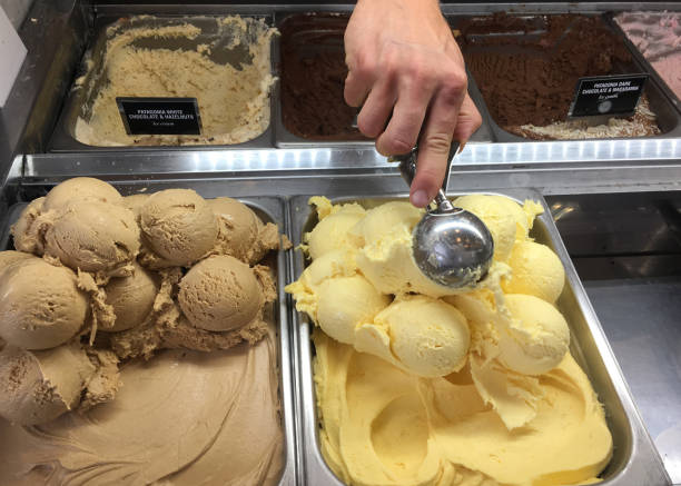 Close-up shot of unrecognizable staff serving a scoop of gelato