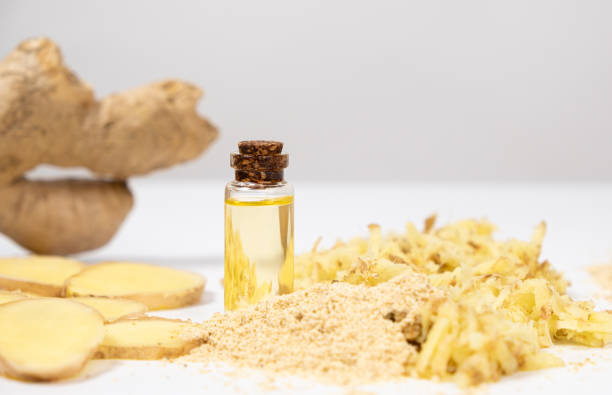istock Natural ginger oil in glass bottle among ginger roots 2156944707