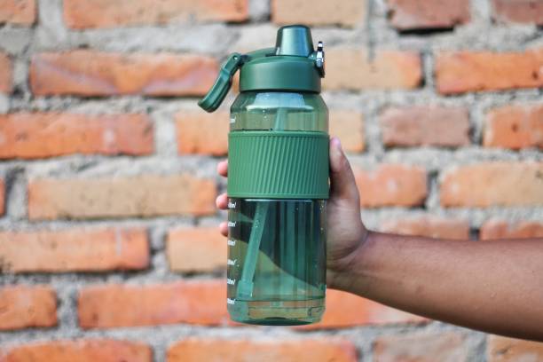 istock man holding bottle of drink 2156945807