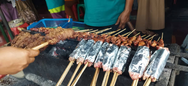 istock Defocused of Sate Buntel or Satay Buntel is satay made from minced mutton wrapped in mutton fat is being grilled on charcoal 2156949117