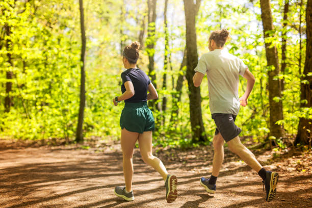 istock Couple jogging and running outdoors in nature 2156950921