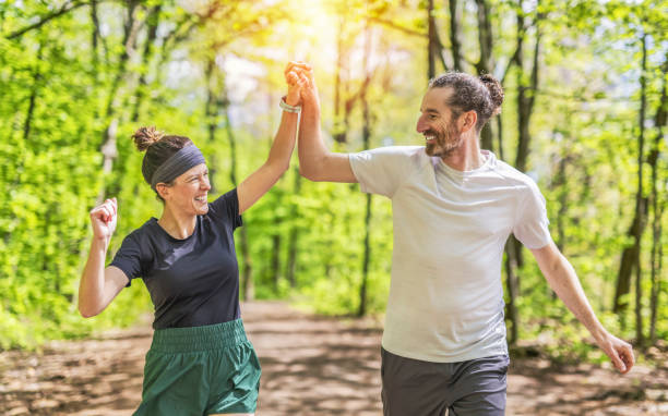 istock Couple jogging and running outdoors in nature 2156950928