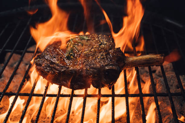 istock A Tomahawk Steak Engulfed in Flames from the Charcoal Grill 2156953873