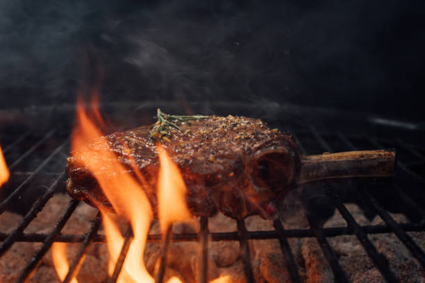 istock A Tomahawk Steak Surrounded By Flames From the Charcoal Grill 2156953938