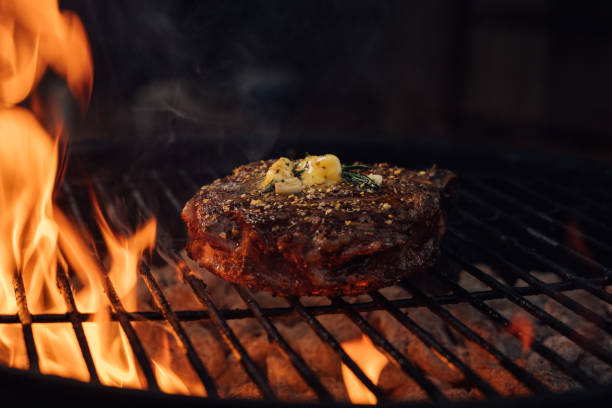 istock A Large Juicy Steak on a Charcoal Grill With Flames 2156953981