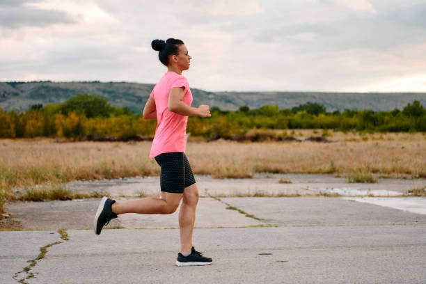 istock Determined Athlete Running in the Sun amidst Beautiful Nature 2156954609