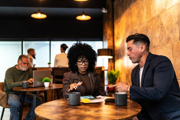 istock Coworkers talking during meeting at coffee shop 2156955741