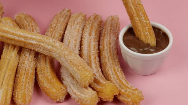 istock several churros, close-up, on a pink background 2156955915