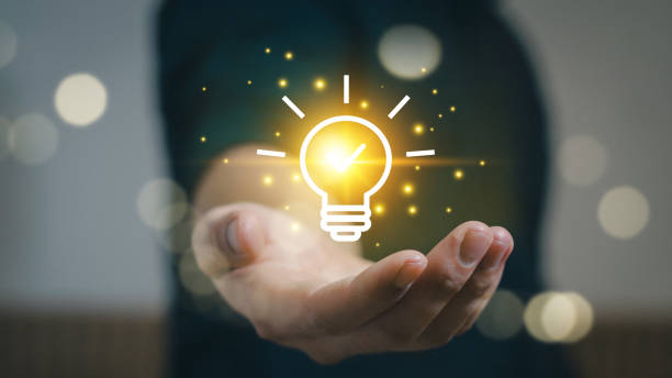istock Man holding light bulbs, ideas of new ideas with innovative technology and creativity. concept creativity with bulbs that shine glitter.  innovative technology in science and communication concept. 2156958891