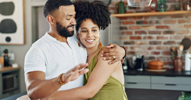 istock Kitchen, talking and couple hug in home for bonding, loving relationship and commitment together. Happy, marriage and man and woman embrace for affection, romance and love for new house or apartment 2156961236