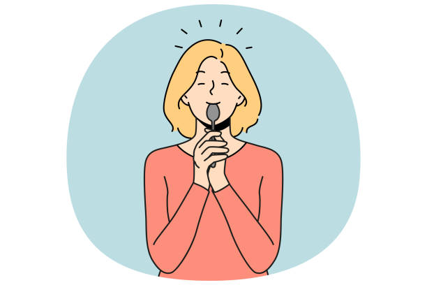 istock Smiling woman lick spoon after tasty food 2156961553