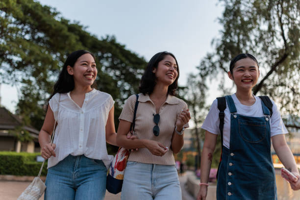 istock Friends walking in a park 2156964066