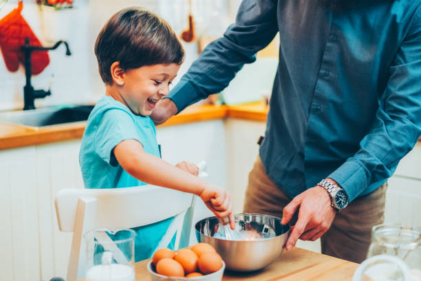 istock Kid enjoying to cook with his father 2156967678