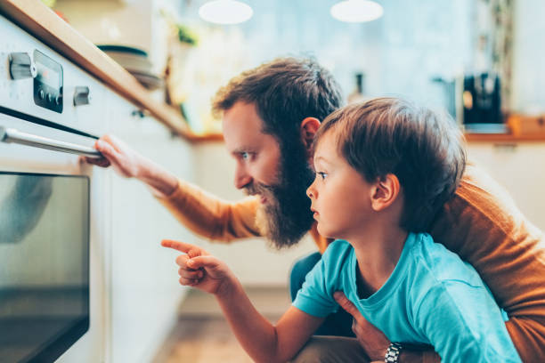 istock Father and son cooking dinner at home 2156968519