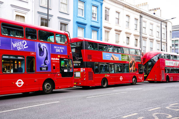 Kensington and Chelsea, London England United Kingdom Britain Europe – 09 June 2024: The luxury residential street and a major road located at Notting Hill Gate district, West London, UK. A red London double decker bus on  street  Featuring the \