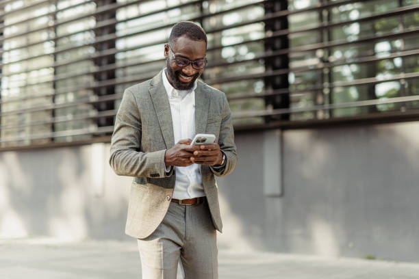 istock Businessman using phone in the city 2156969599