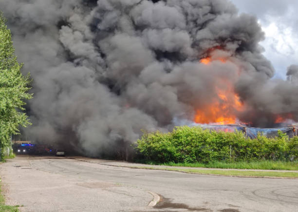 istock There is a fire in the city, powerful fire and black smoke, the workshop is burning. 2156970670