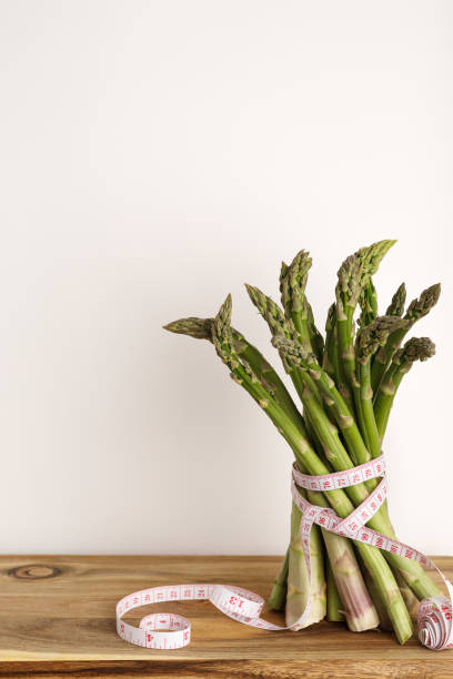 istock Fresh asparagus with measuring tape with copy space 2156970854