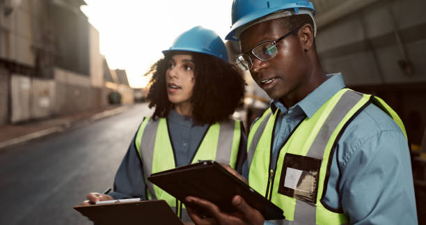 istock Construction, discussion and people on tablet for planning, teamwork and maintenance. Civil engineering, architecture and man and woman on digital tech for project, infrastructure and manufacturing 2156970896