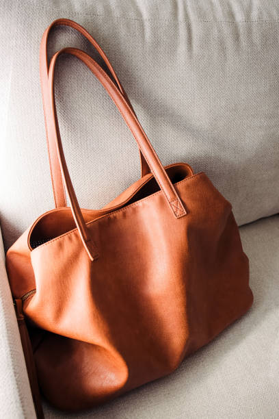 istock Brown leather bag standing on the sofa 2156971660