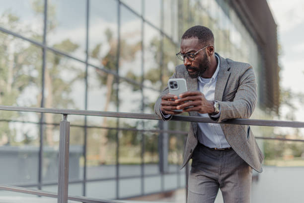 istock A handsome black man in a suit leaning against the fence 2156972875