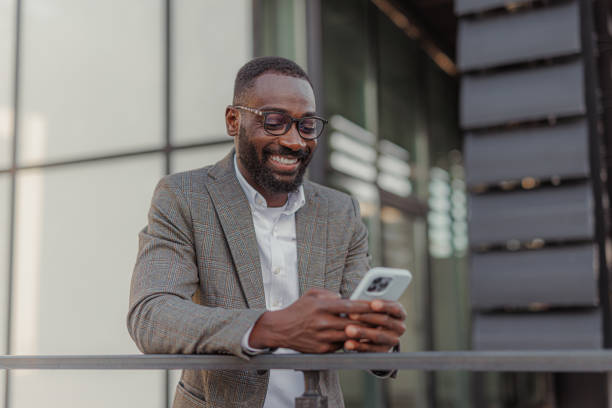 istock A handsome black man in a suit leaning against the fence 2156974447
