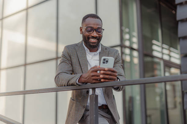 istock A handsome black man in a suit leaning against the fence 2156974726
