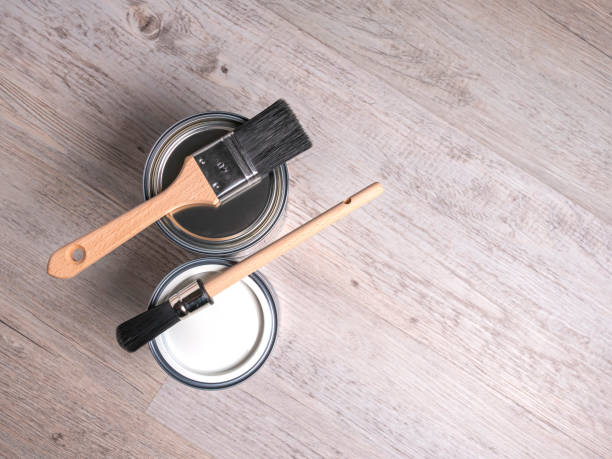 istock Paint cans with two clean brushes, top view, wooden background, copy space. 2156975357