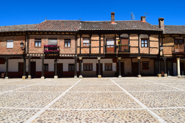 istock Timber frame houses on pillar / colonnade lined portico on Spanish cobbled square 2156977589
