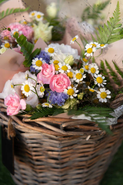 istock A wicker basket with bright wildflowers. Close-up 2156978828
