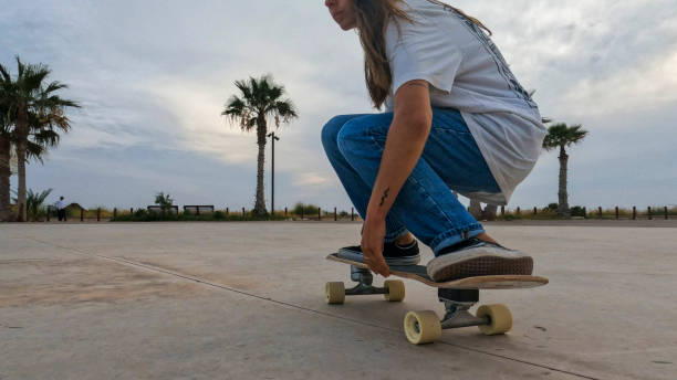 istock Young woman skateboards in courtyard 2156979714