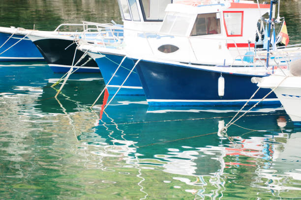 Polperro Cornwall UK 11th July 2025 \nSuch a pretty harbour and fishing village. Calm waters where the relection mirrored the boats in the harbour. Pretty white stone house line the harbour