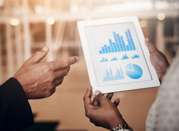 istock Hands, graphs and tablet for financial review strategy, data report and growth chart statistics. Business people, infographic and information by discussion, screen with analytics and company target 2156980373