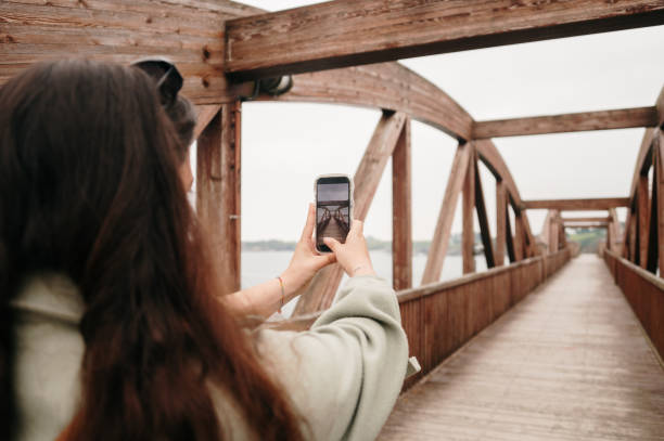 istock Woman on a pedestrian bridge taking a picture 2156980680