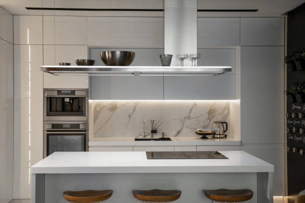 istock Metal hanging kitchen hood in white modern kitchen with island 2156980821