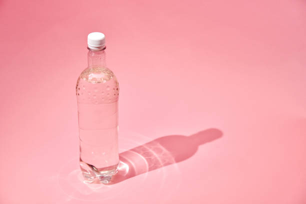 Water in Recycled PET Plastic Bottle on Pink Background