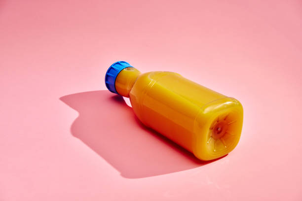 Orange Juice in Recycled PET Plastic Bottle on Pink Background