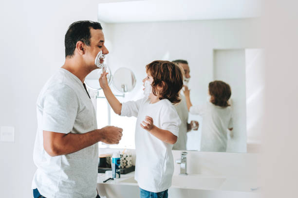 istock Father and son having fun shaving father's day 2156983759