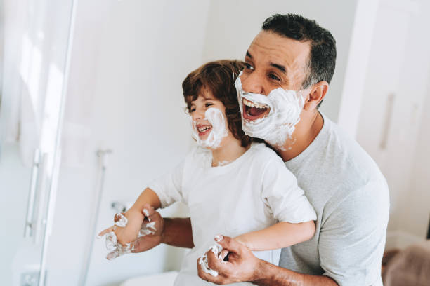 istock Father and son having fun shaving father's day 2156983762