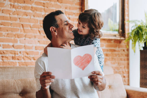 istock Son handing postcard to father on father's day 2156983771