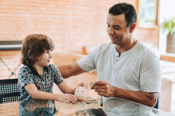 istock Father and son coin bank 2156983820
