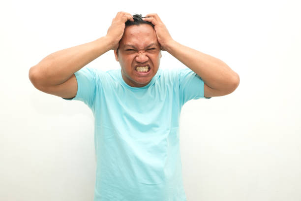 asian man feeling headache isolated on white background