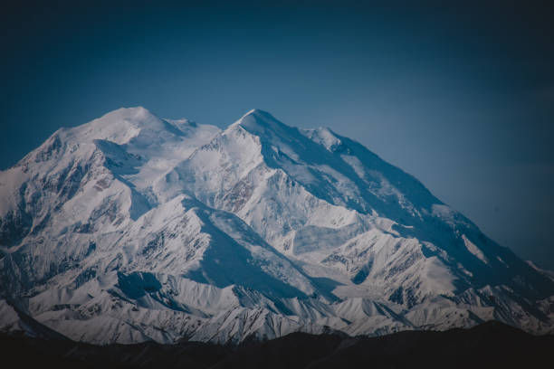 Behold the towering snow-covered peaks of Alaska, captured in their pristine beauty. This image encapsulates the serene and majestic essence of the wilderness, perfect for nature and travel themes.
