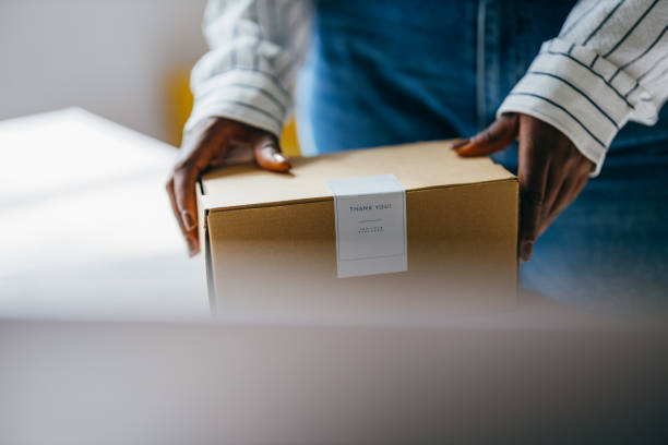 istock Person Receiving Package with Thank You Note at Home 2156987546