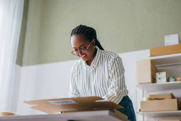 istock Young Woman Preparing Shipment in a Home Office 2156987558