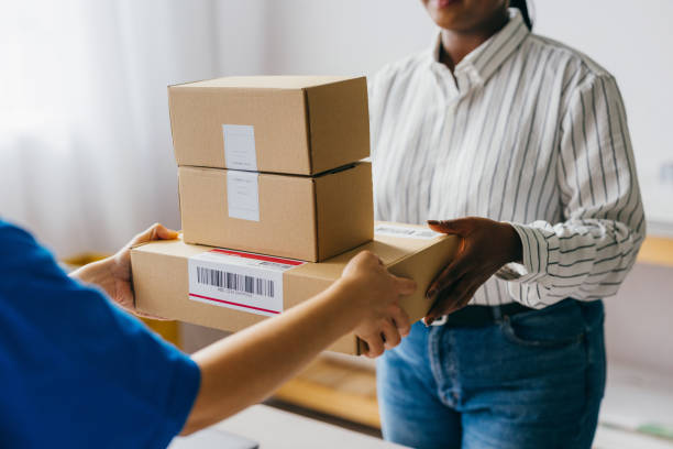 istock Courier Delivering Packages to Customer at Home 2156987570